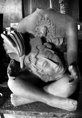 Mayan statue with a head in its lap